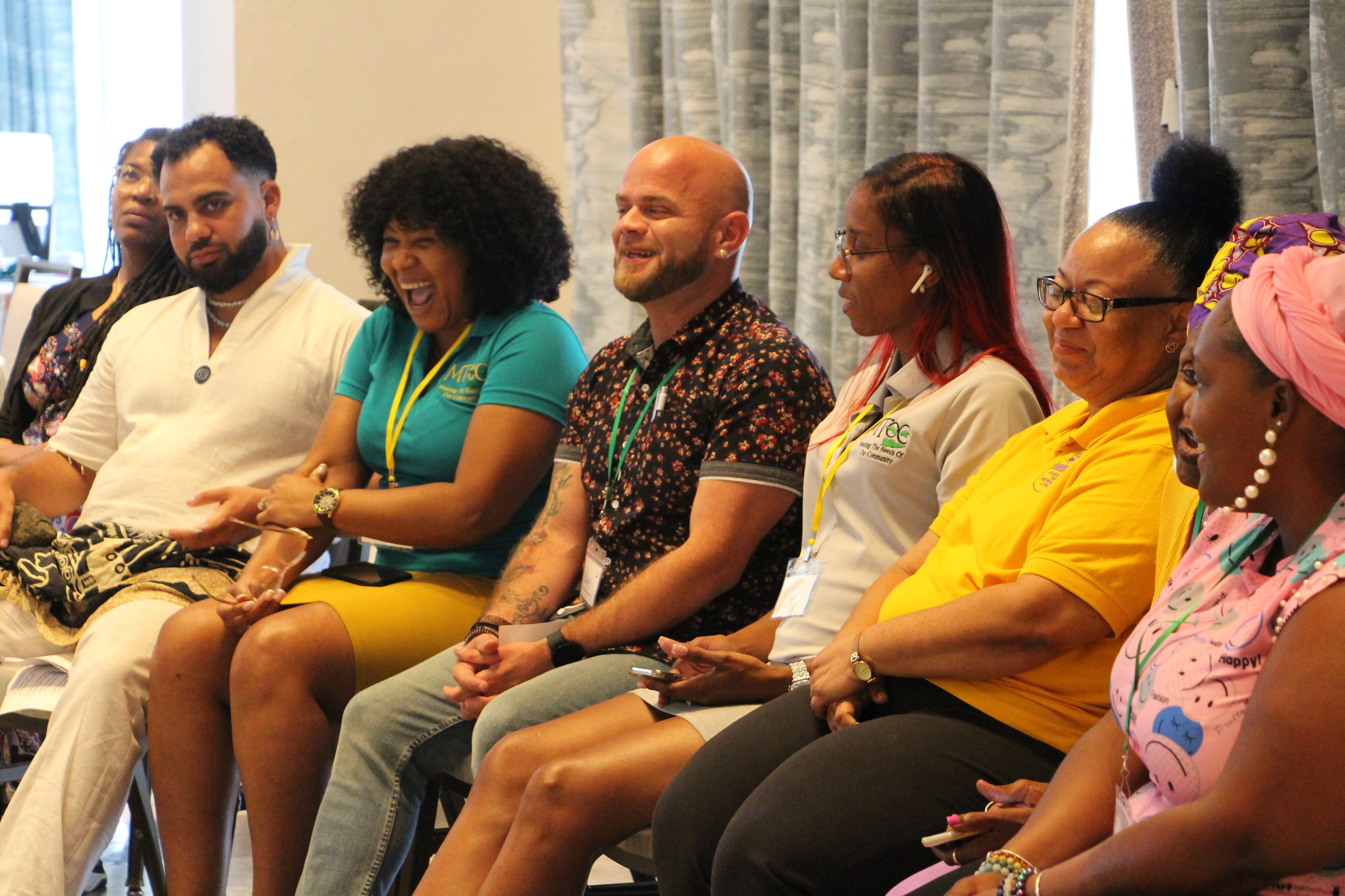 Conference participants laughing and engaged in a community session