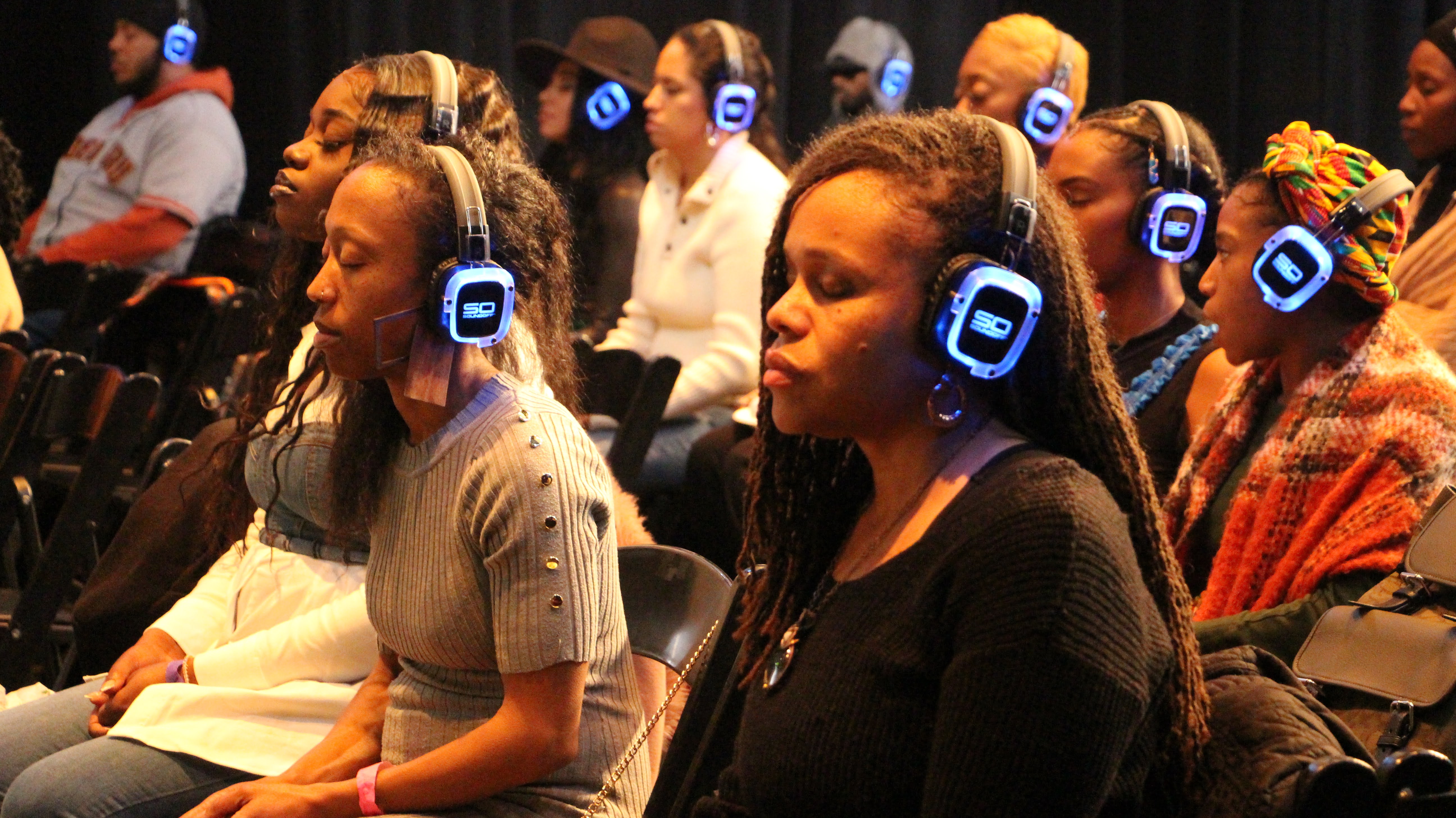 Participants in silent meditation with headphones